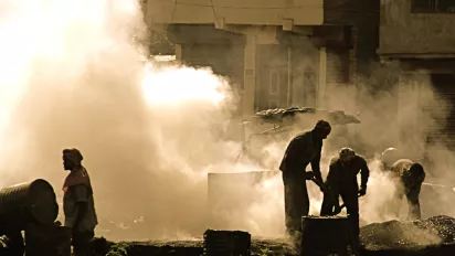 Workers in the heat and fumes of chemical products in the street