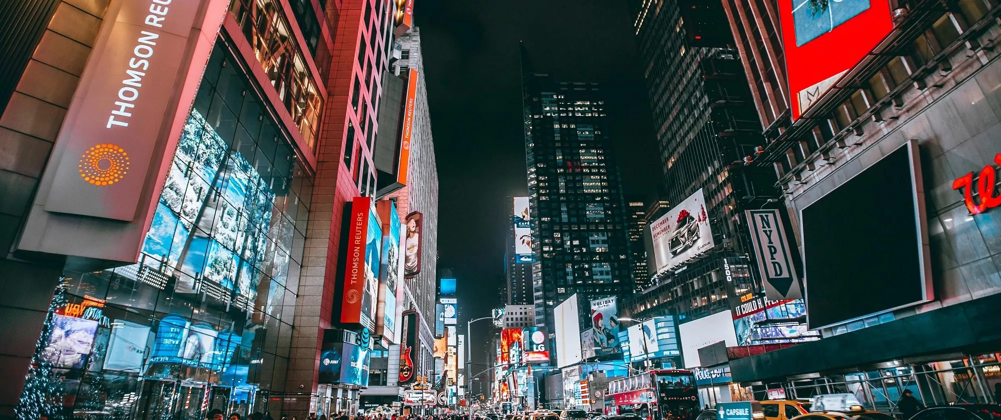 Photo of a busy commercial street at night.